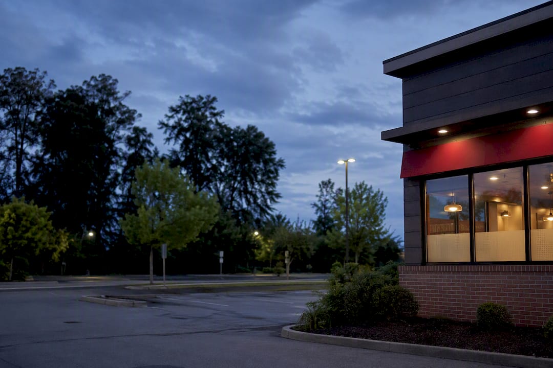 Franchised fast food restaurant exterior at dusk