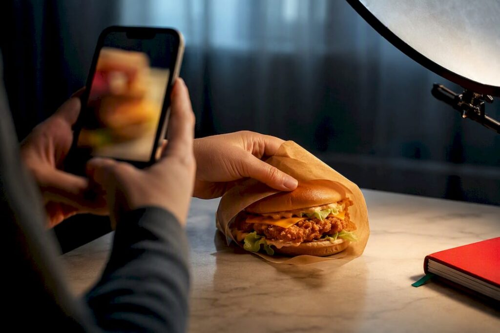 Hands filming anonymous fast-food content